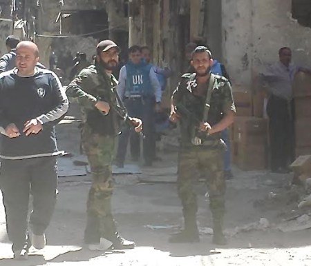 Palestinian "volunteer forces" stand guard while NGOs tend to Yarmouk camp residents receiving food aid, medical assistance and evacuation.Palestinian "volunteer forces" stand guard while NGOs tend to Yarmouk camp residents receiving food aid, medical assistance and evacuation. - Photo by Sharmine Narwani